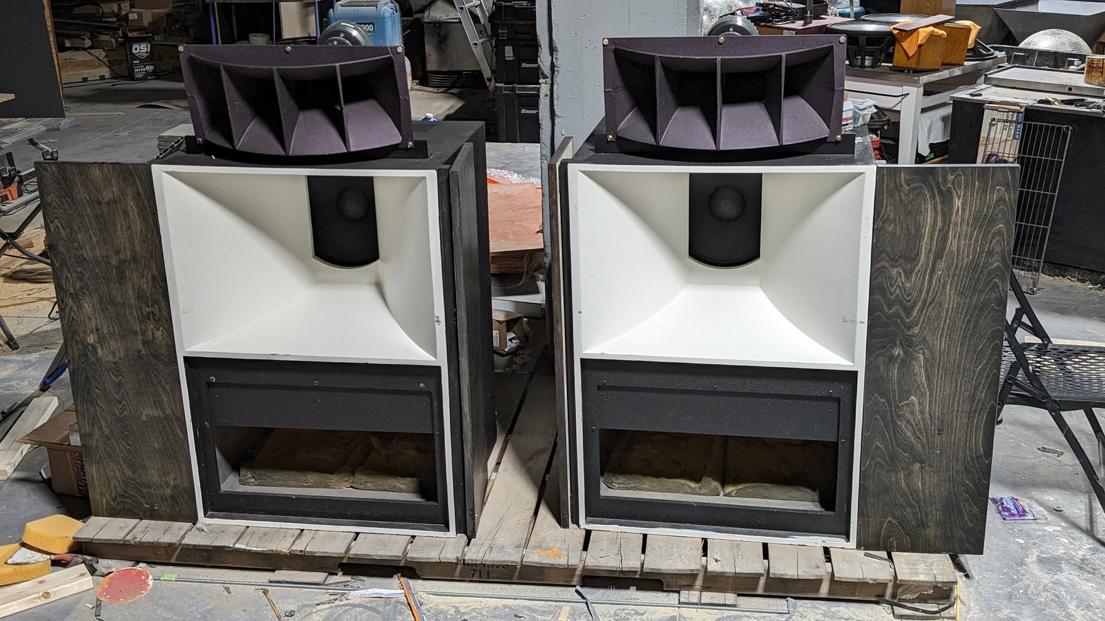 A pair of vintage large-format loudspeaker cabinets being worked on in the Sound Logic workshop